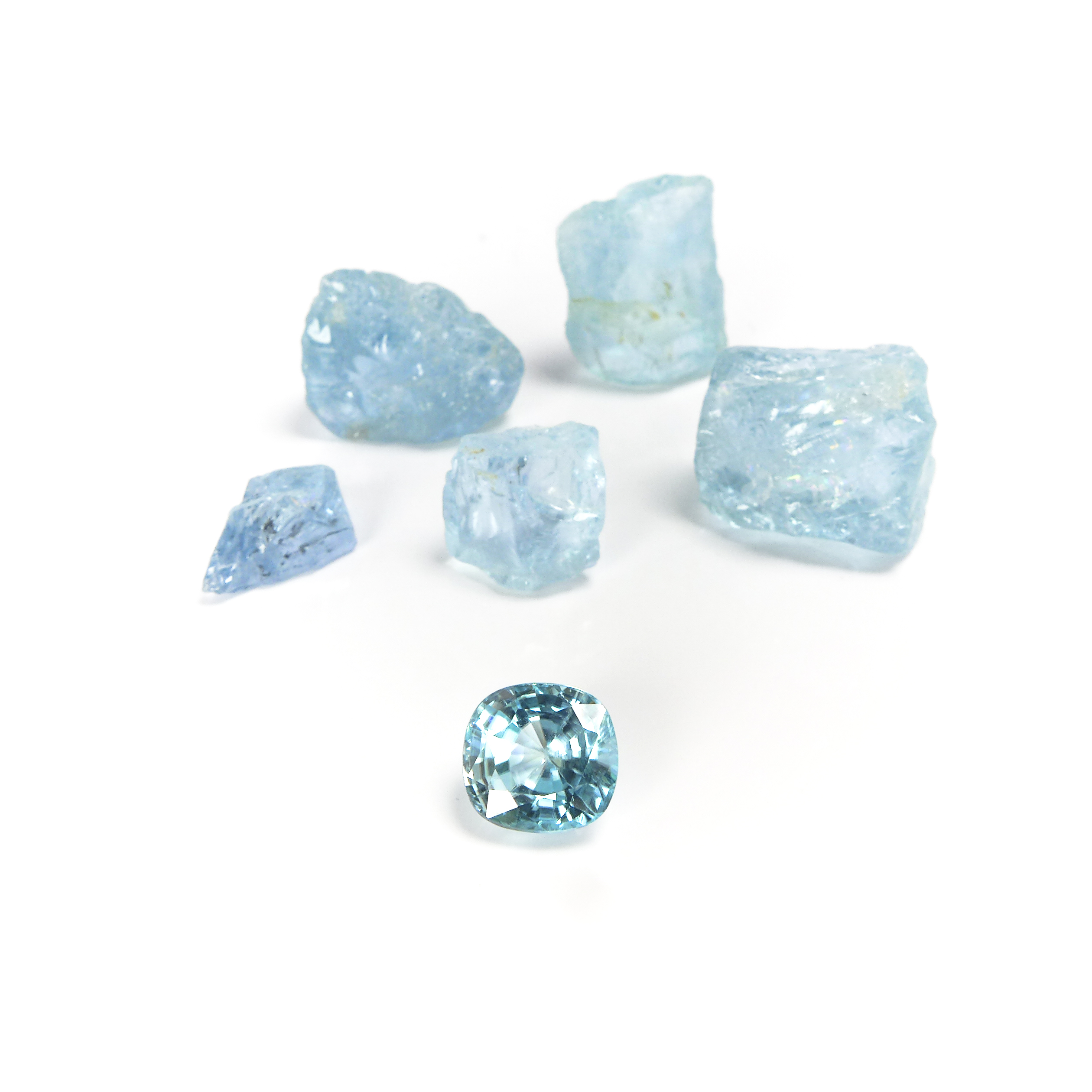 cut and rough aquamarine stones